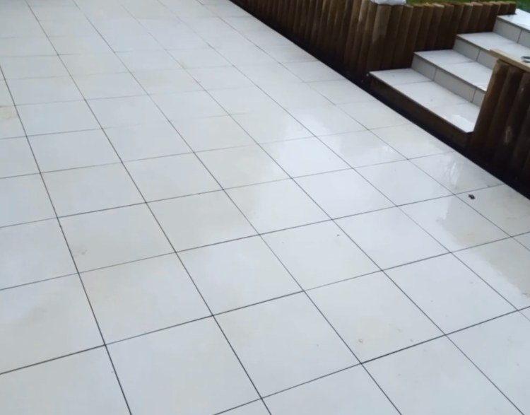 Large white tiled patio with steps