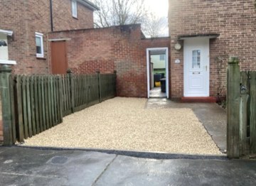 Gravel front area leading to a house entrance